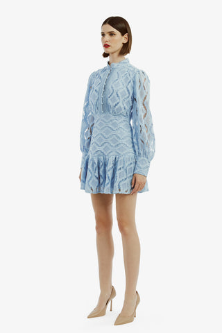 Woman in the Bardot Remy Lace Mini Dress in Blue